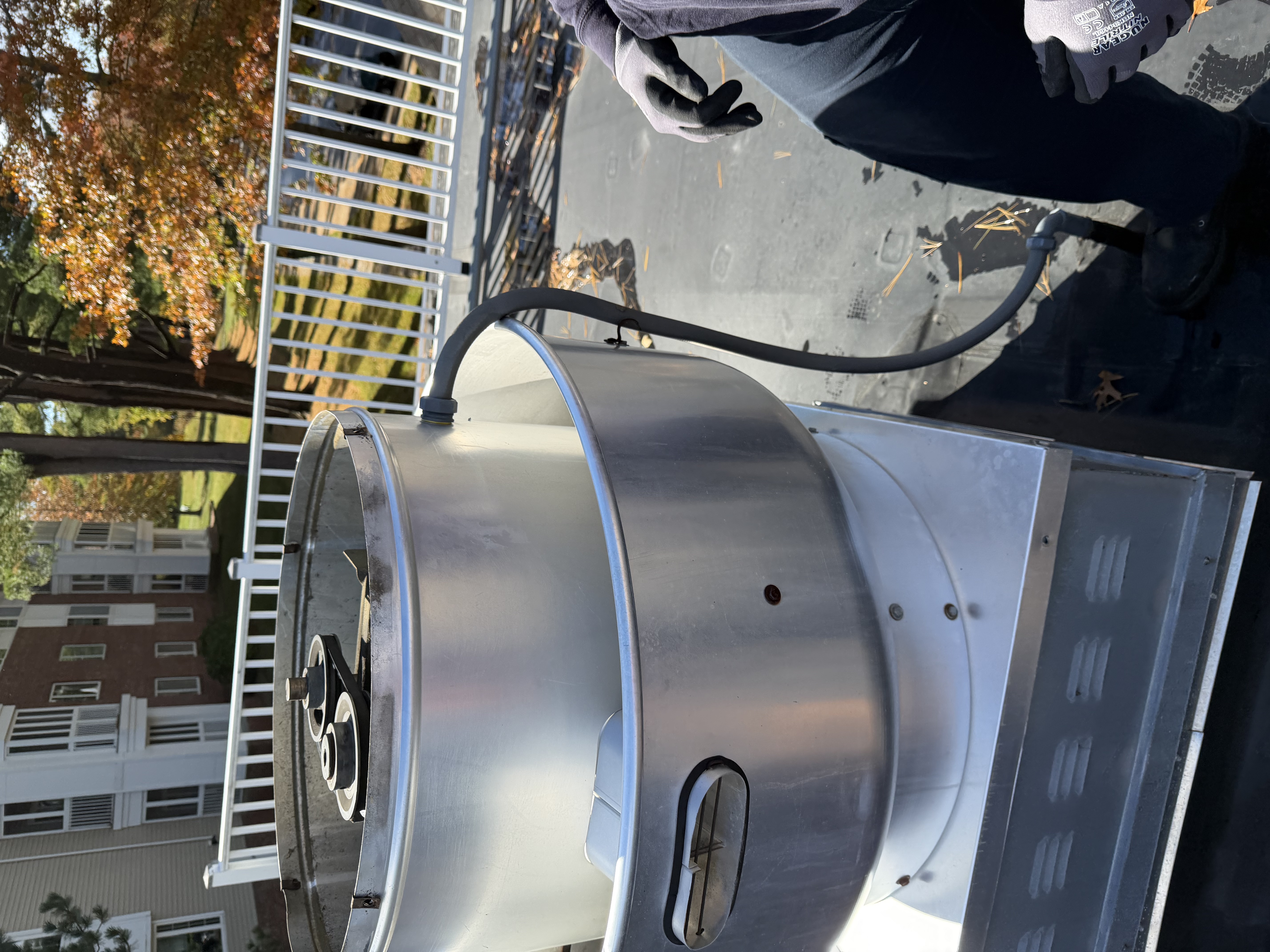 Commercial kitchen exhaust fan on a rooftop showing a worn unit ready for replacement